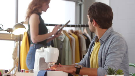 stilisti di abbigliamento maschi e femmine che lavorano insieme in uno studio di moda