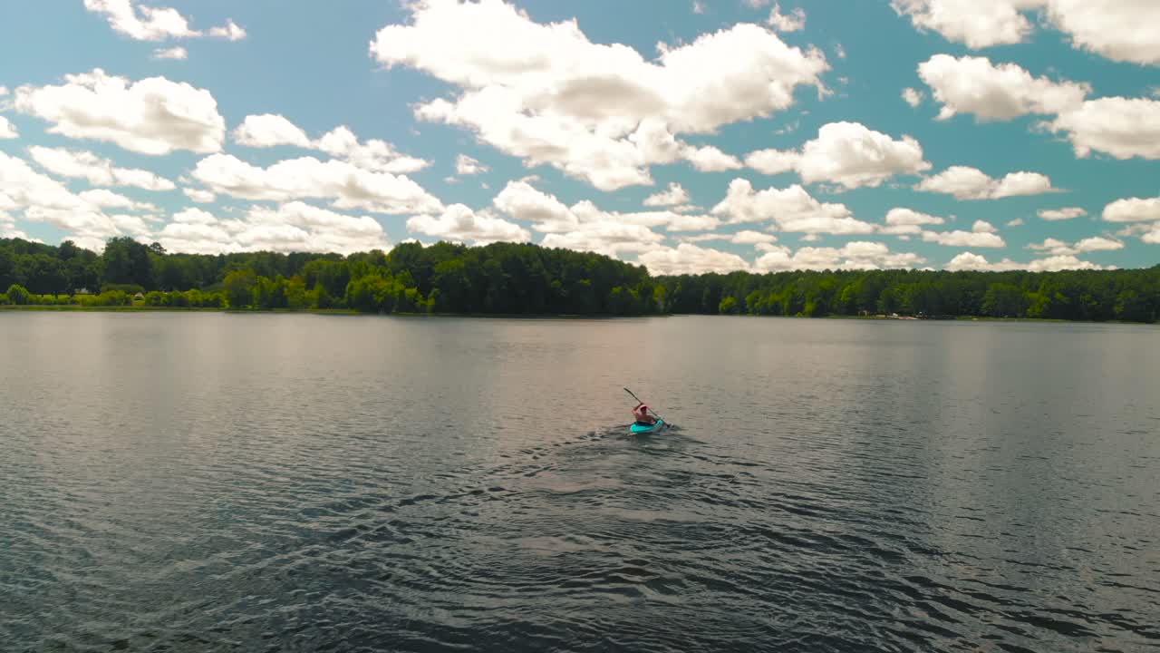 hombre haciendo kayak en un lago
