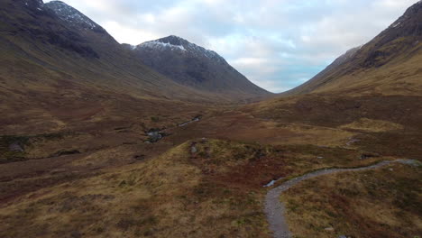 low level aerial shot of the valley bottom of the hills and mountains at glencoe, scotland in great britain