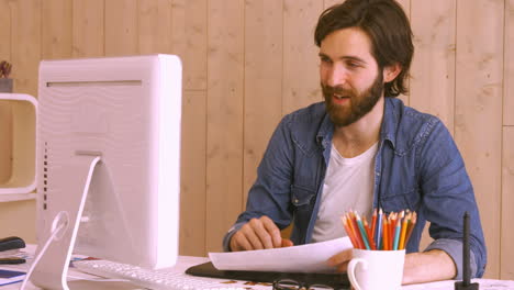 Hipster-worker-using-video-chat-at-desk