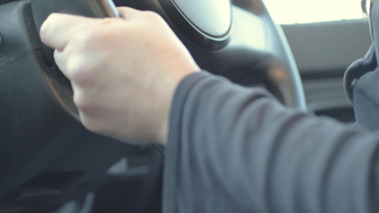 Woman gets into driver seat of car to start journey close up shot