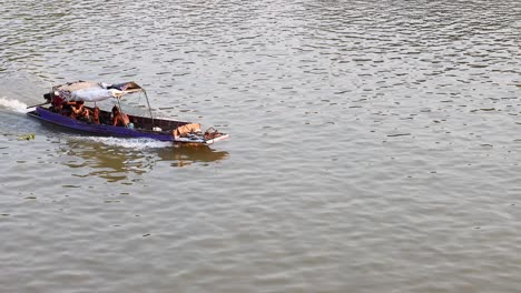 a boat travels along a river in ayutthaya