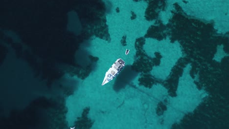 Yacht-boat-ship-sailing-at-pristine-turquoise-clear-water-beach-bay-on-Palma-de-Mallorca-Island