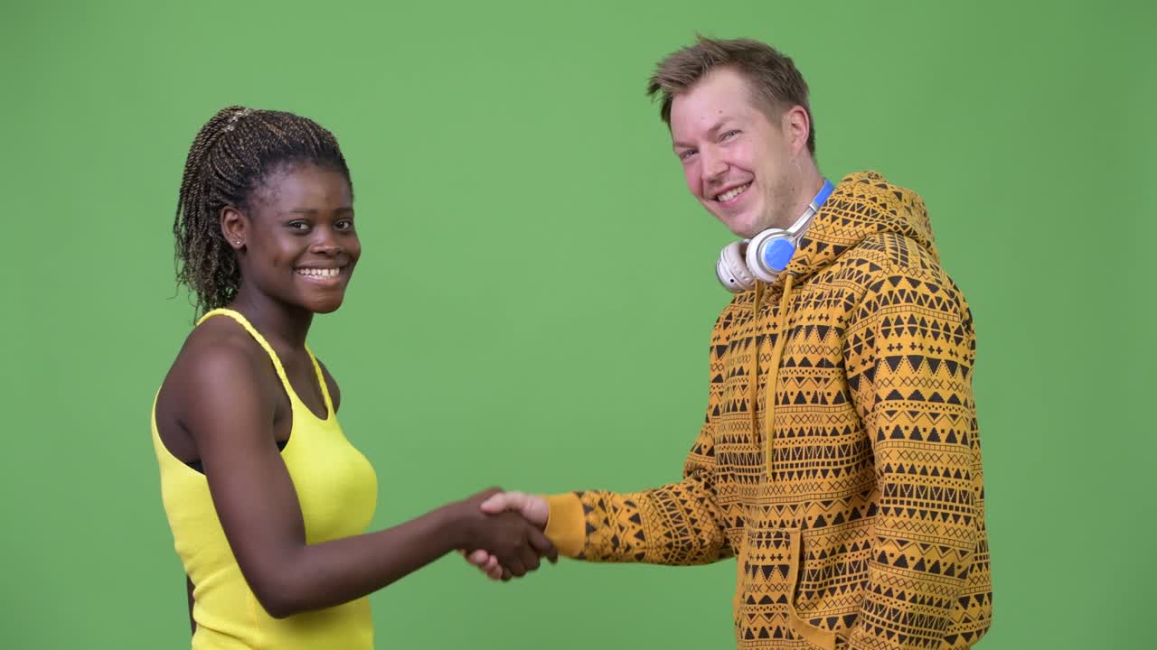 Young multi-ethnic couple shaking hands together