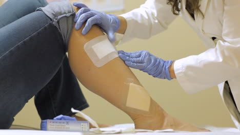 doctor checking a patient's leg injury