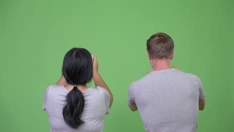 young multi-ethnic couple photographing with phone together