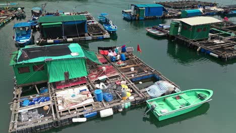 aerial over the fishing boats and rafts of the fish farms on ma wan island, hong kong, china