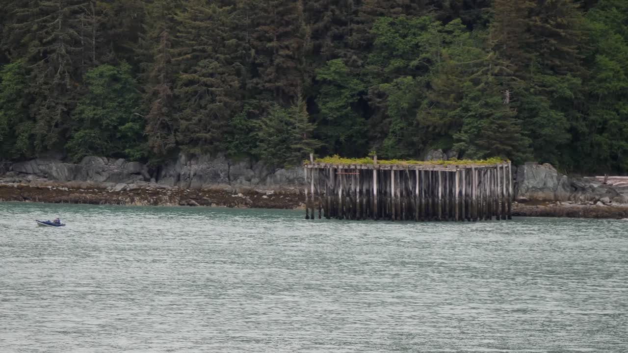 Sailing down the Gastineau Channel on a cloudy and rainy day, heading towards Juneau, Alaska.Old deserted pontoon.