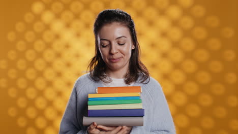 Portrait-of-happy-woman-with-stack-of-books-in-hands-showing-thumbs-up