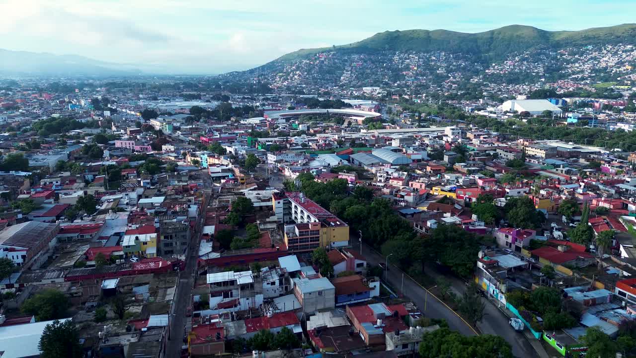 Drone aerial landscape of residential housing buildings streets and roads in Oaxaca city neighbourhood town Mexico urban travel tourism suburbs downtown
