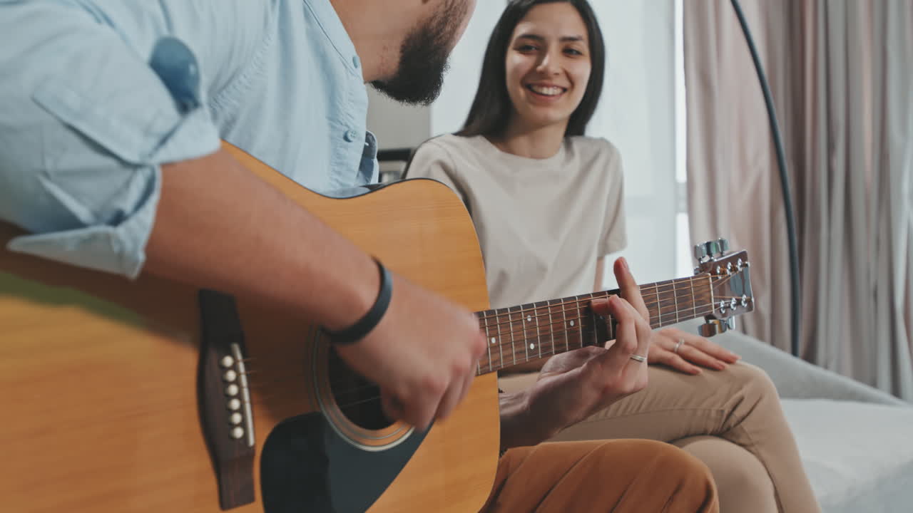 Man Playing Guitar And Singing To His Girlfriend