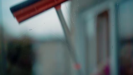 young girl washes windows 3 closeup