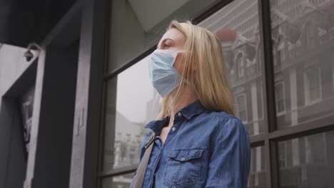 Low-angle-view-of-Caucasian-woman-wearing-a-coronavirus-Covid19-mask