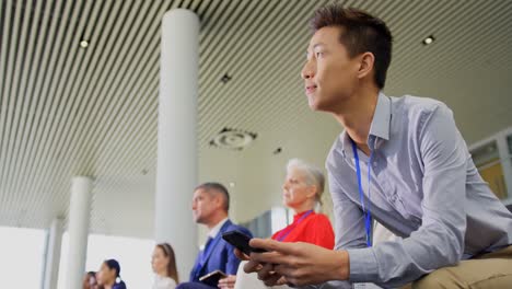 asian businessman using his mobile phone in the business seminar 4k