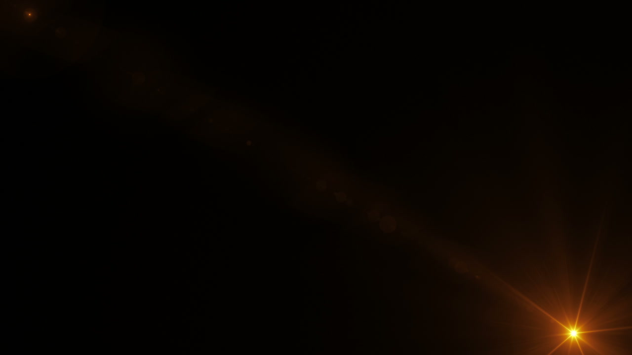 Dynamiske farverige lens flares bevæger sig på en sort baggrund