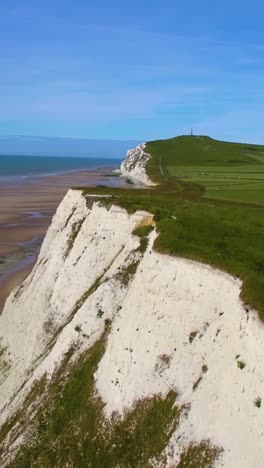 aerial reveal ascends the bright white chalk cliffs of le petit blanc nez in france