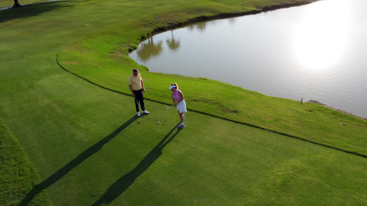 Couple playing golf on a beautiful golf course