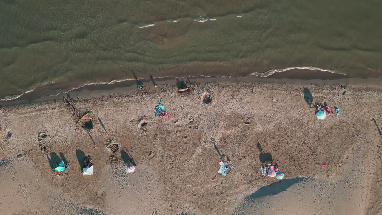 Aerial Drone fly slow above white sand and clear water of a French beach summer