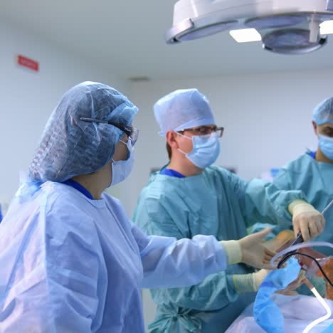 group of doctors perform an operation to a patient. surgeons in medical uniform and masks working in the operating room