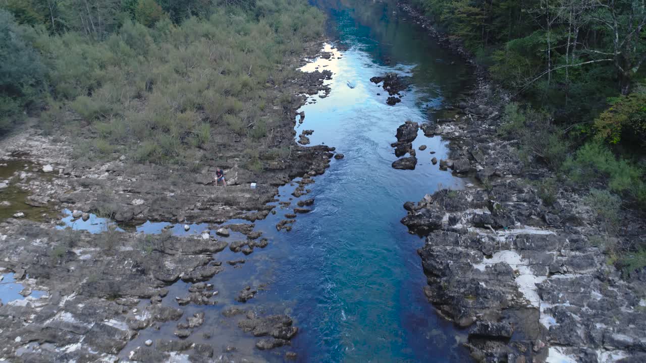 fly over stream, water flowing, forest and rocky shores of Kolpa river, Kostel