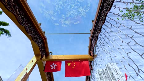 chinese and hong kong flags flutter in harmony