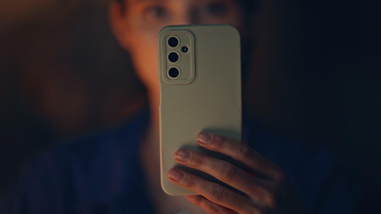 Girl watching social media at smartphone late evening closeup. Serious woman