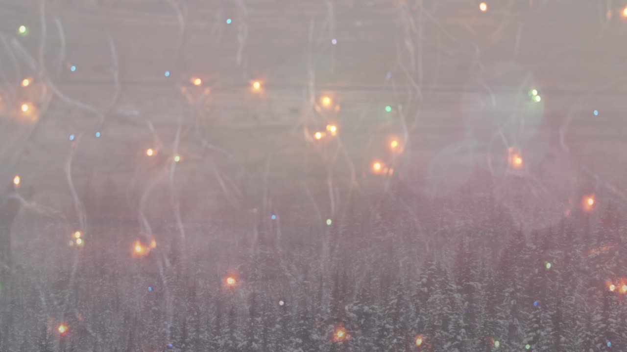 Animaatio: Hehkuvat jouluvalonauhat talvimaiseman yllä.