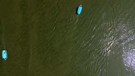 Top-down-aerial-of-covered-boats-on-the-water