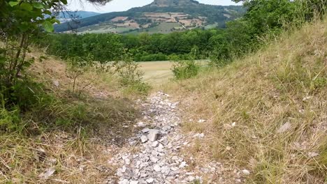 pov-tilt-up-a-rocky-path-towards-an-edge-with-perfect-view-on-franconian-mountain-"Staffelberg