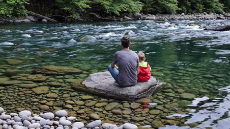 father and son enjoying a day by the river