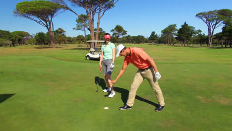 Feliz-Pareja-De-Jugadores-De-Golf-Chocando-Esos-Cinco