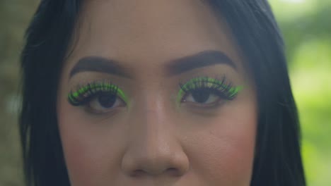 epic portrait of a young latin woman eyes with green cosmetic make up