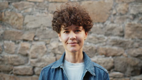 woman with curly hair in denim jacket