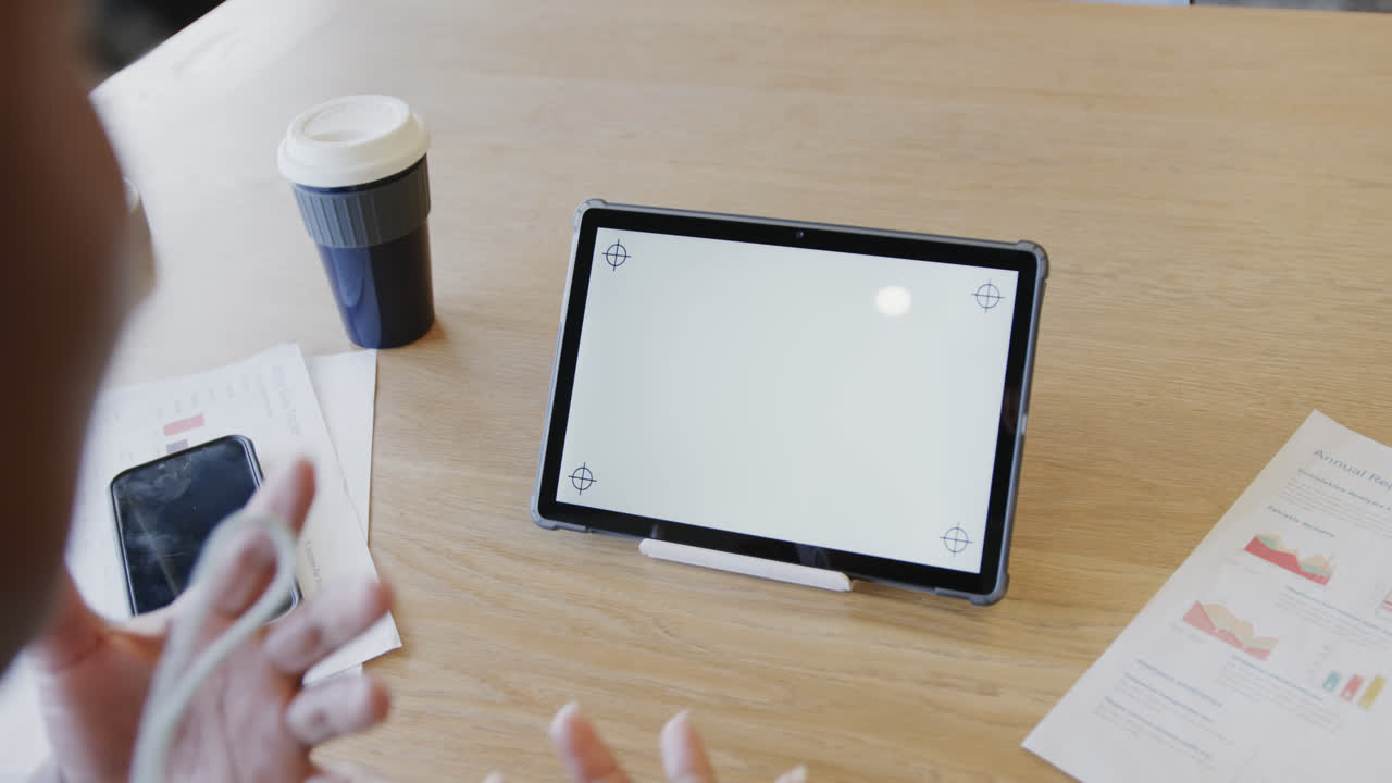 Hands of african american businesswoman making video call on tablet with copy space, slow motion