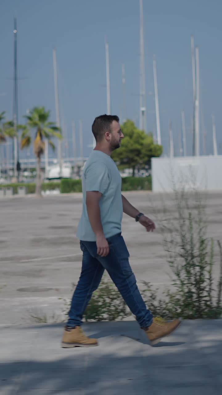 Man walking near a marina