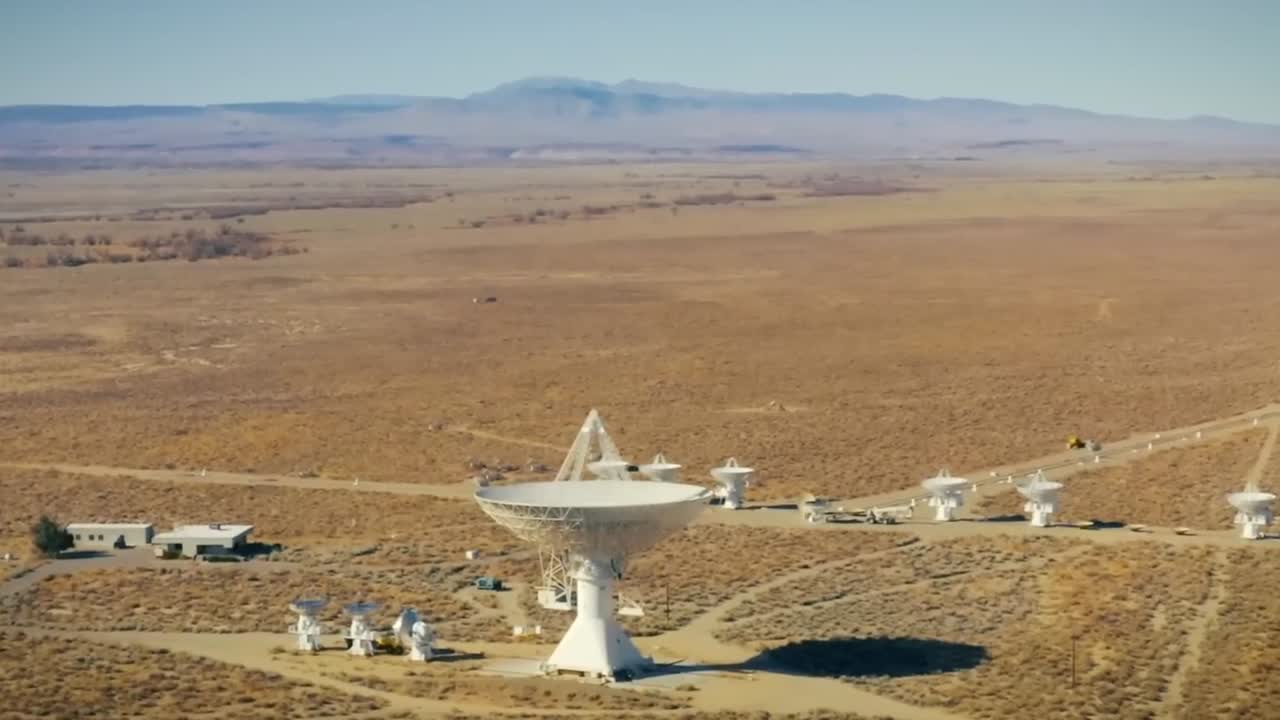 Aerial view of Radio Telescopes in a desert landscape.