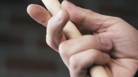 closeup of hands playing drum sticks