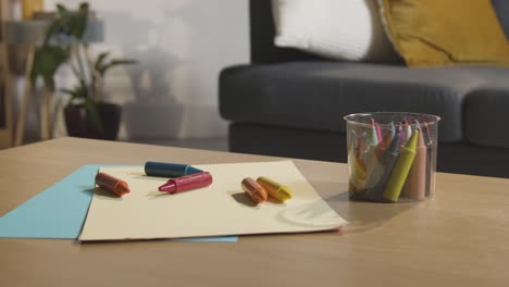 coloured crayons and paper on table at home for child diagnosed with asd 1