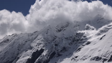 Large-white-clouds-moving-over-mountains-in-a-time-lapse-in-the-Himalayas,-Nepal