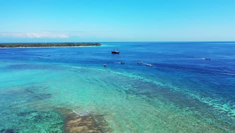 vivid colors of seascape with shallow calm water of turquoise lagoon surrounded by coral reef bordered by deep blue sea in bali