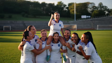 joyful women's soccer team celebrating victory on the field