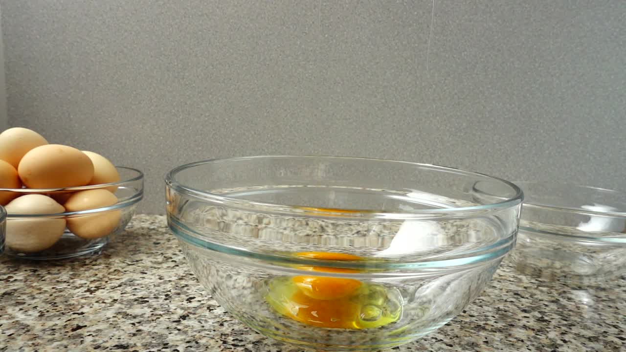 Falling of contents of egg in a bowl. Slow motion