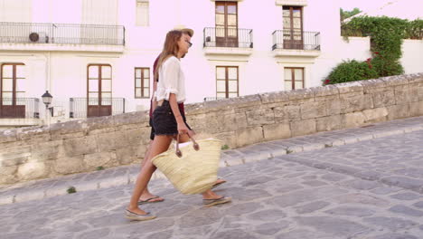 Young-couple-walking-together-on-vacation-in-Ibiza,-Spain,-shot-on-R3D