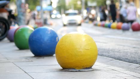 colorful bollards on a city street