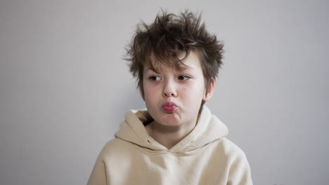 boy with messy hair in hoodie
