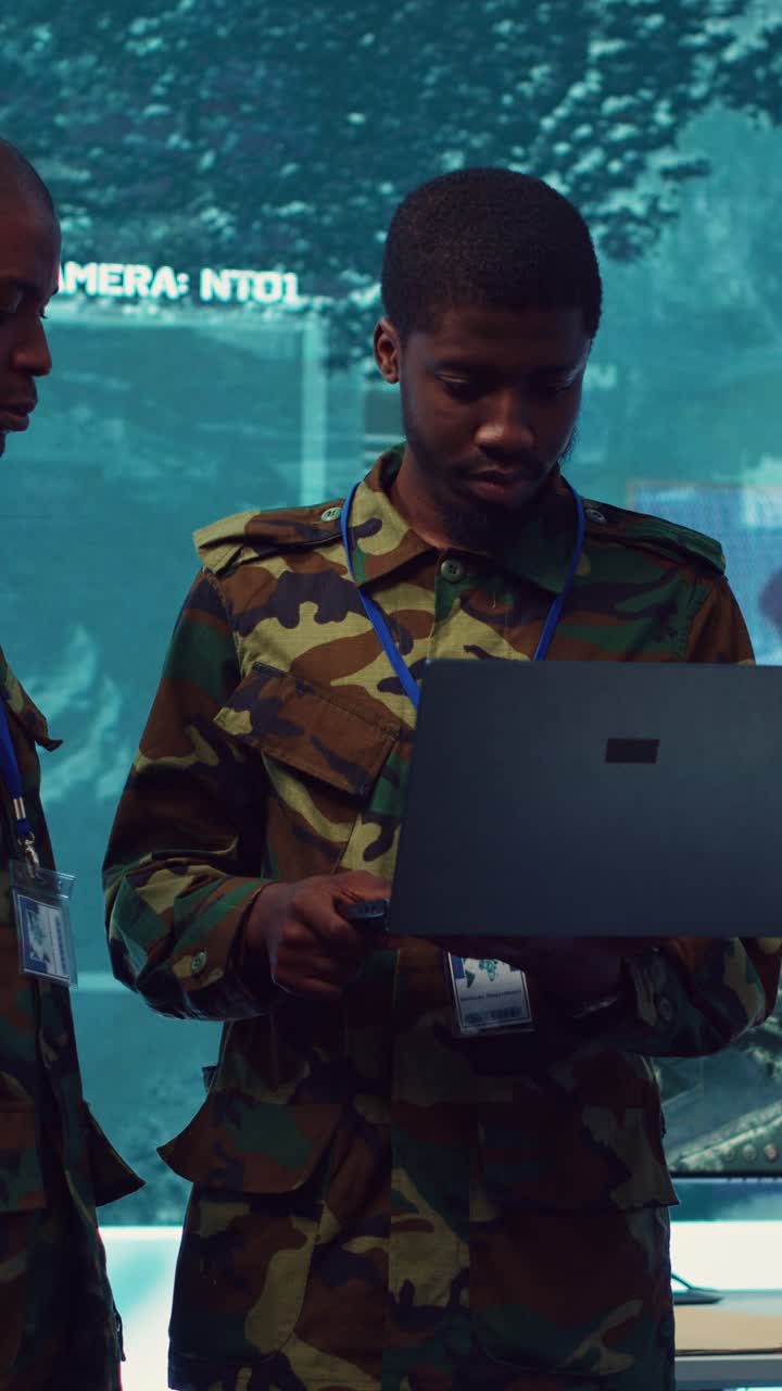 Soldiers in Camouflage Uniforms Discussing Data in Control Room