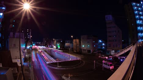 a night timelapse of the traffic jam at the city street in tokyo fish-eye shot