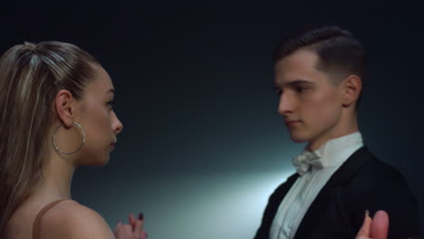 sensual dance couple dancing indoors. ballroom dancers looking each other inside