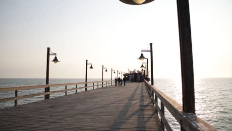 Golden-hour-sun-revealed-by-a-lamp-on-the-Swakopmund-Jetty-in-Namibia-at-sunset