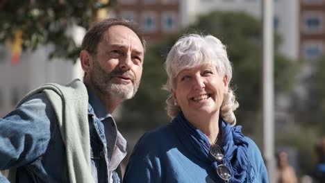happy mature man and woman talking during walk